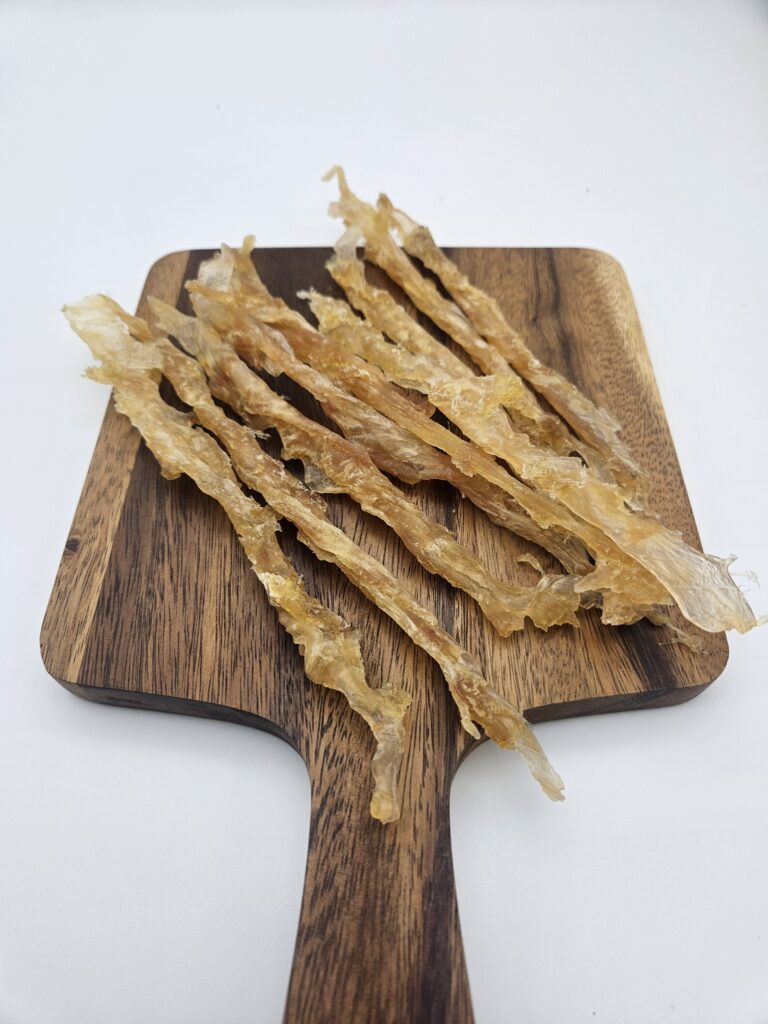 Premium, single-ingredient natural turkey tendon for dogs on a table